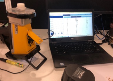 Vanta M Series analyzer docked in a field stand and connected to a PC.
