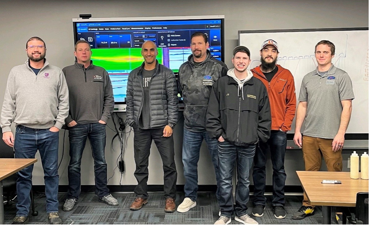 Kakivik Asset Management NDT inspection technicians at the University of Ultrasonics training with OmniScan image on large display